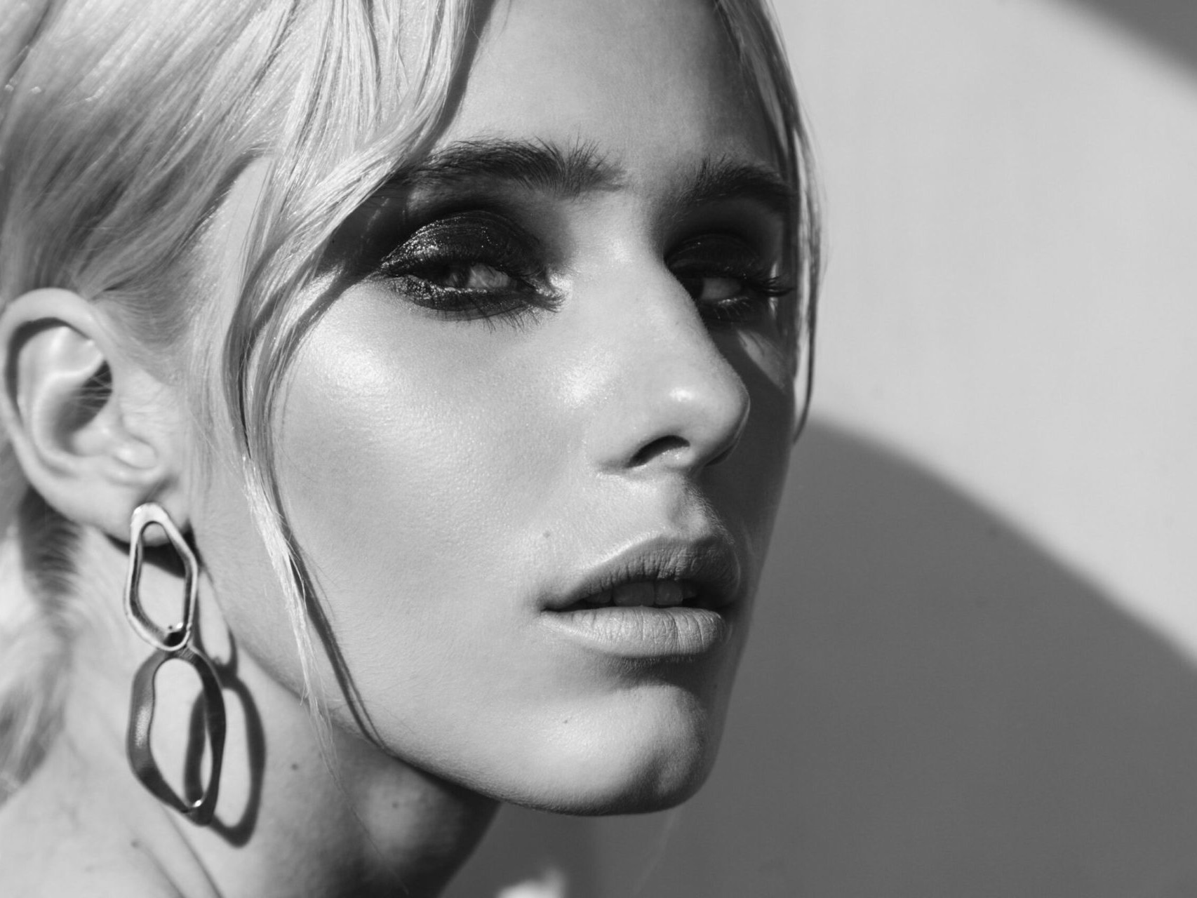 Fashion beauty portrait of young beautiful woman wearing earring