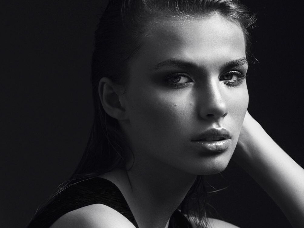 Black and white portrait of a beautiful girl in the studio on a